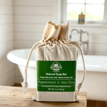 Load image into Gallery viewer, Bath Nutts farmhouse raw milk &amp; tallow peppermint &amp; sea clay soap bar in a cloth bag on a bathroom counter