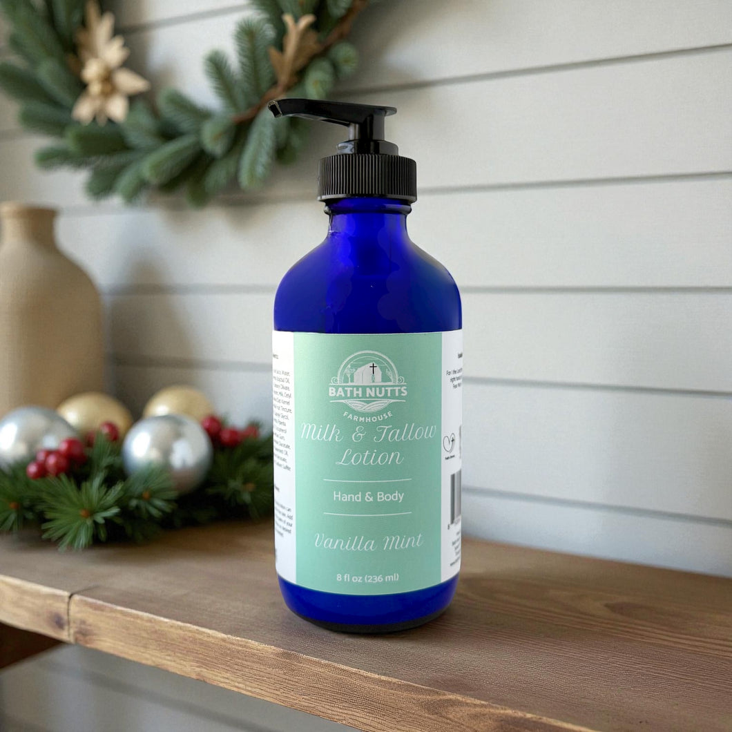 Bath Nutts vanilla mint lotion in blue bottle with pump on a wooden surface, Christmas decorations in the background