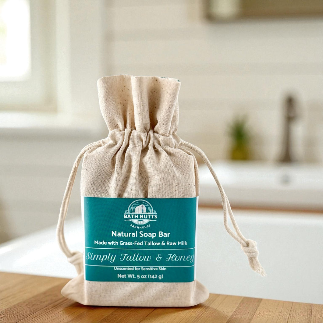 Bath Nutts Natural Soap Bar in a drawstring bag on a wooden surface with a bathroom background.