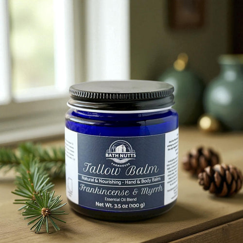 Bath Nutts Tallow Balm jar on a wooden surface with christmas decorative elements