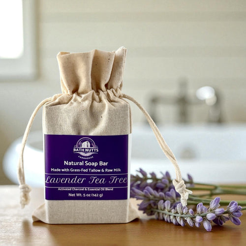 Bath Nutts natural soap bar in a drawstring bag with lavender and tea tree elements.