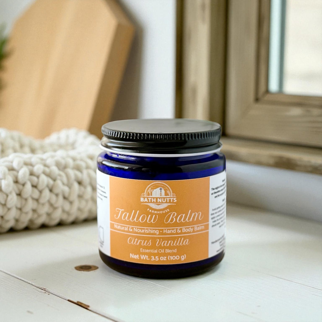 Jar of Bath Nutts Tallow Balm on a wooden surface with a white background
