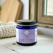 Load image into Gallery viewer, Jar of Bath Nutts Tallow Balm on a wooden surface with a blurred background