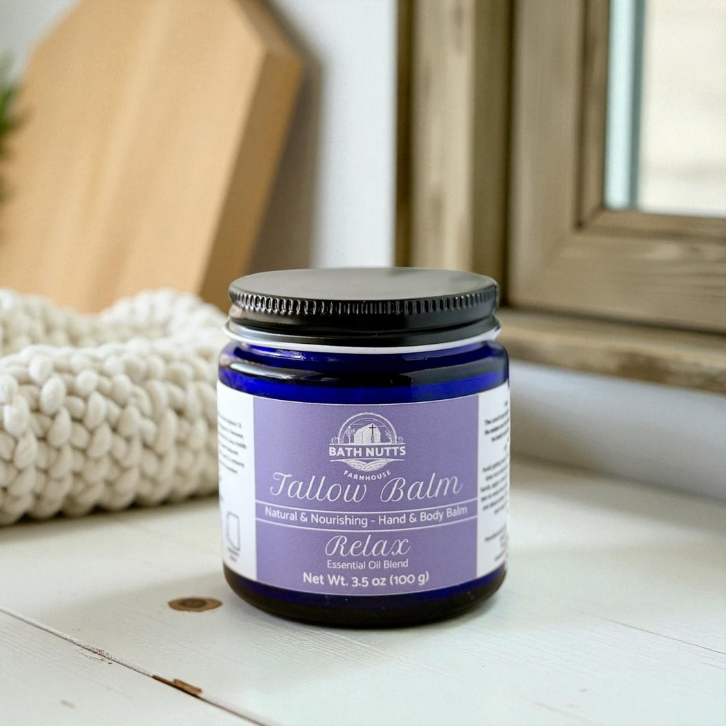 Jar of Bath Nutts Tallow Balm on a wooden surface with a blurred background