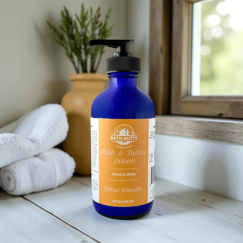 Bath Nutts Citrus Vanilla  lotion in blue bottle on wooden surface with blurred background 