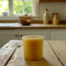 Load image into Gallery viewer, 3&quot;x3&quot; pure beeswax candle on a wooden table with a kitchen background