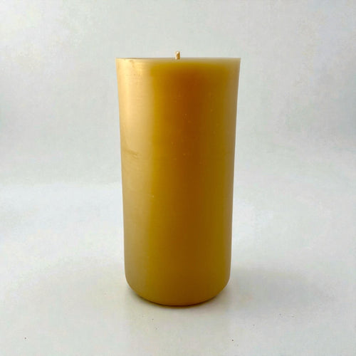 Beeswax candle on a white background