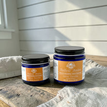 Load image into Gallery viewer, Two jars of Bath Nutts Farmhouse Tallow Balm on a wooden surface with a white wall background.